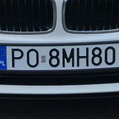 Biała tablica rejestracyjna PO 8MH80 z symbolem UE i PL.