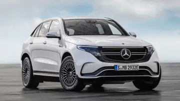 Biały Mercedes EQC, elektryczny SUV, prezentuje się elegancko na tle błękitnego nieba.
